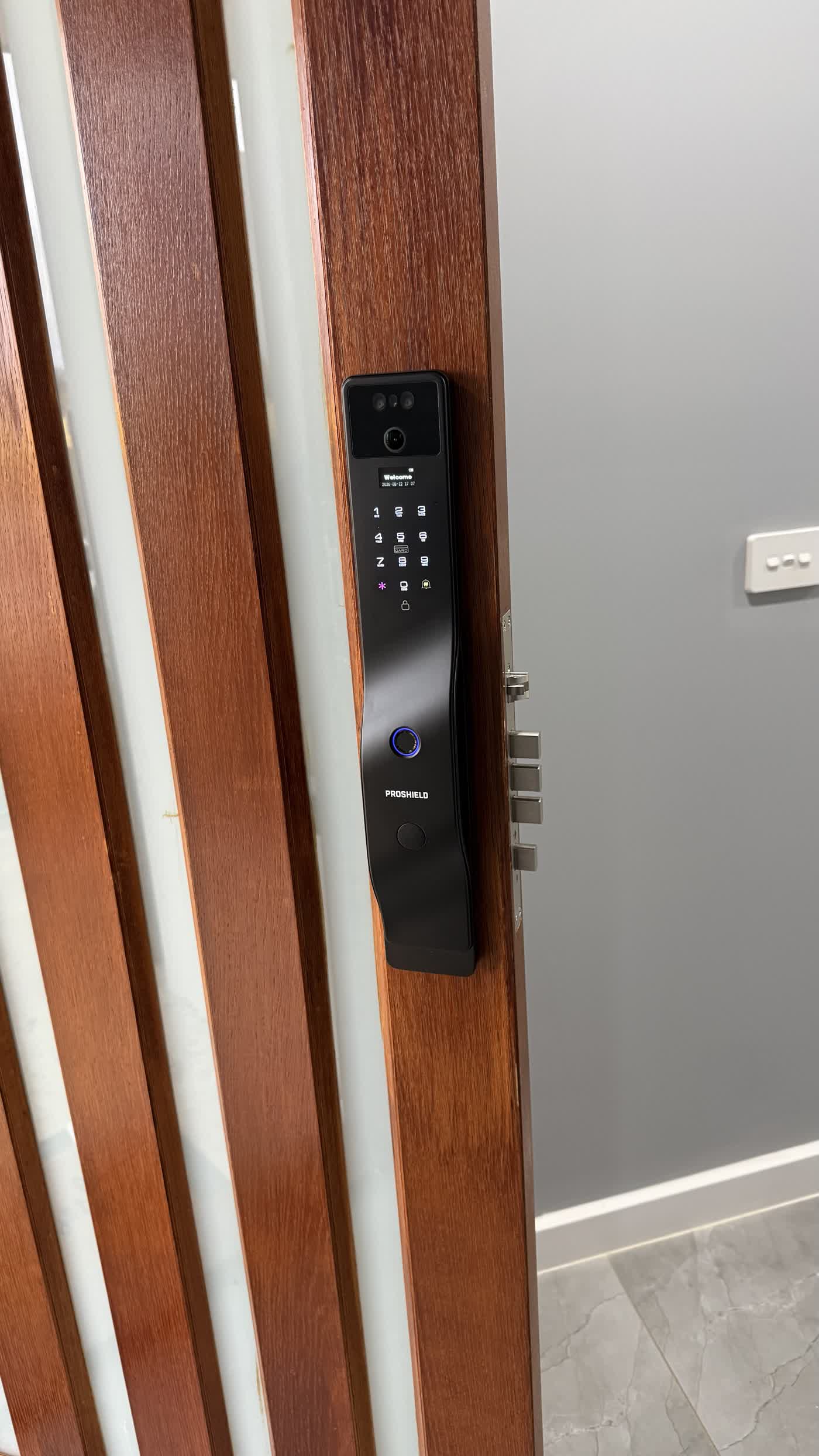 A homeowner unlocking the Guardian smart lock on a real Brisbane & Gold Coast front door